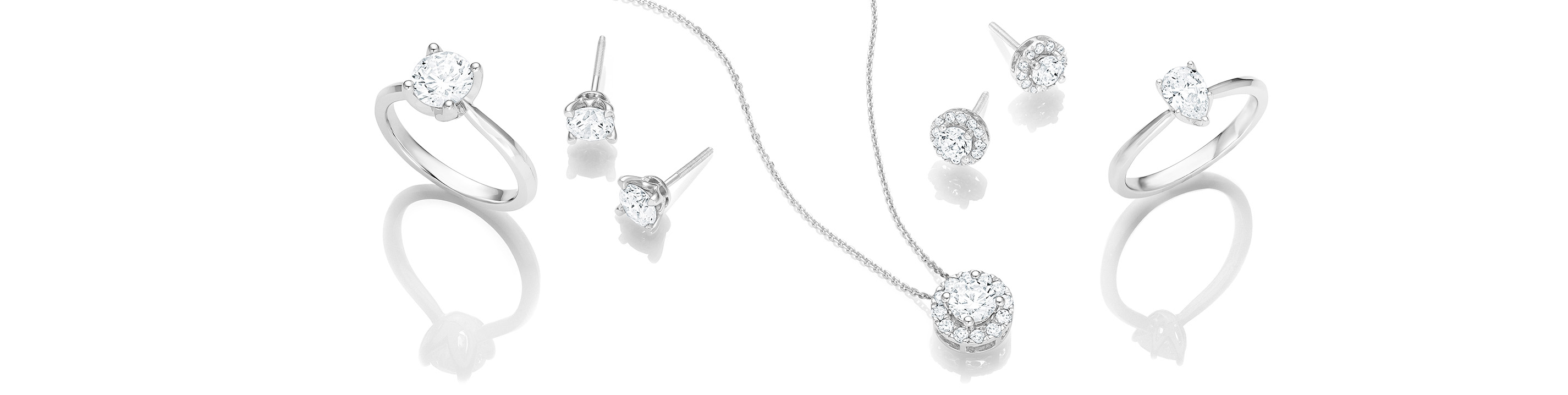 A necklace between two pairs of earings and two rings