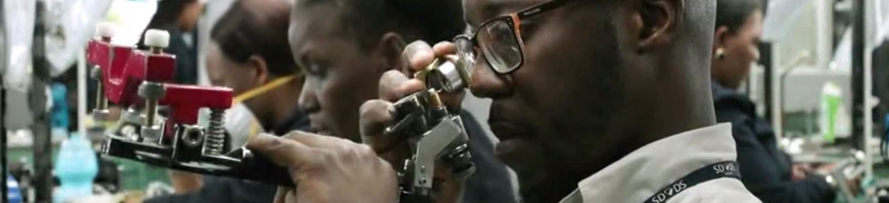 A man in a lab inspects the quality of a diamond