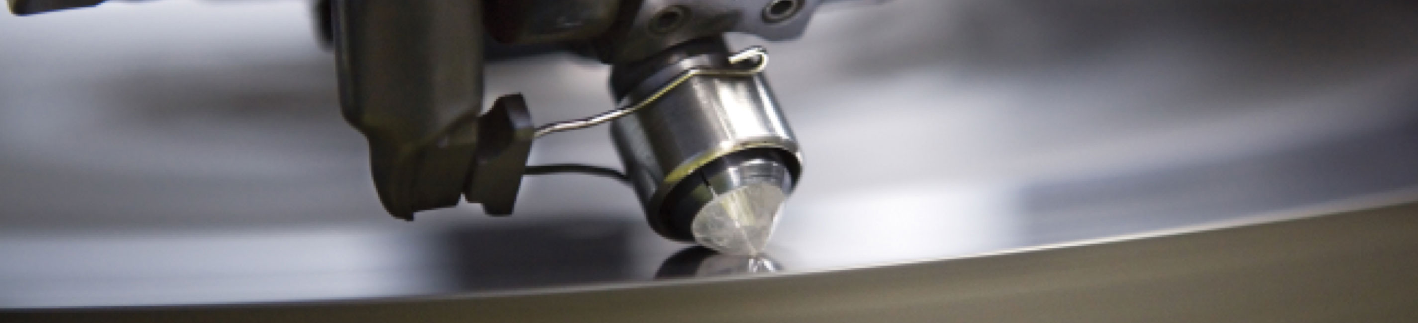 A rough diamond being facetted on a polishing wheel.